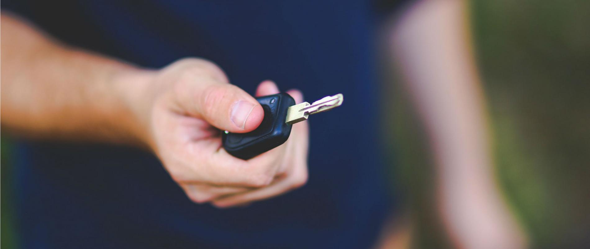 Hand holding a car key